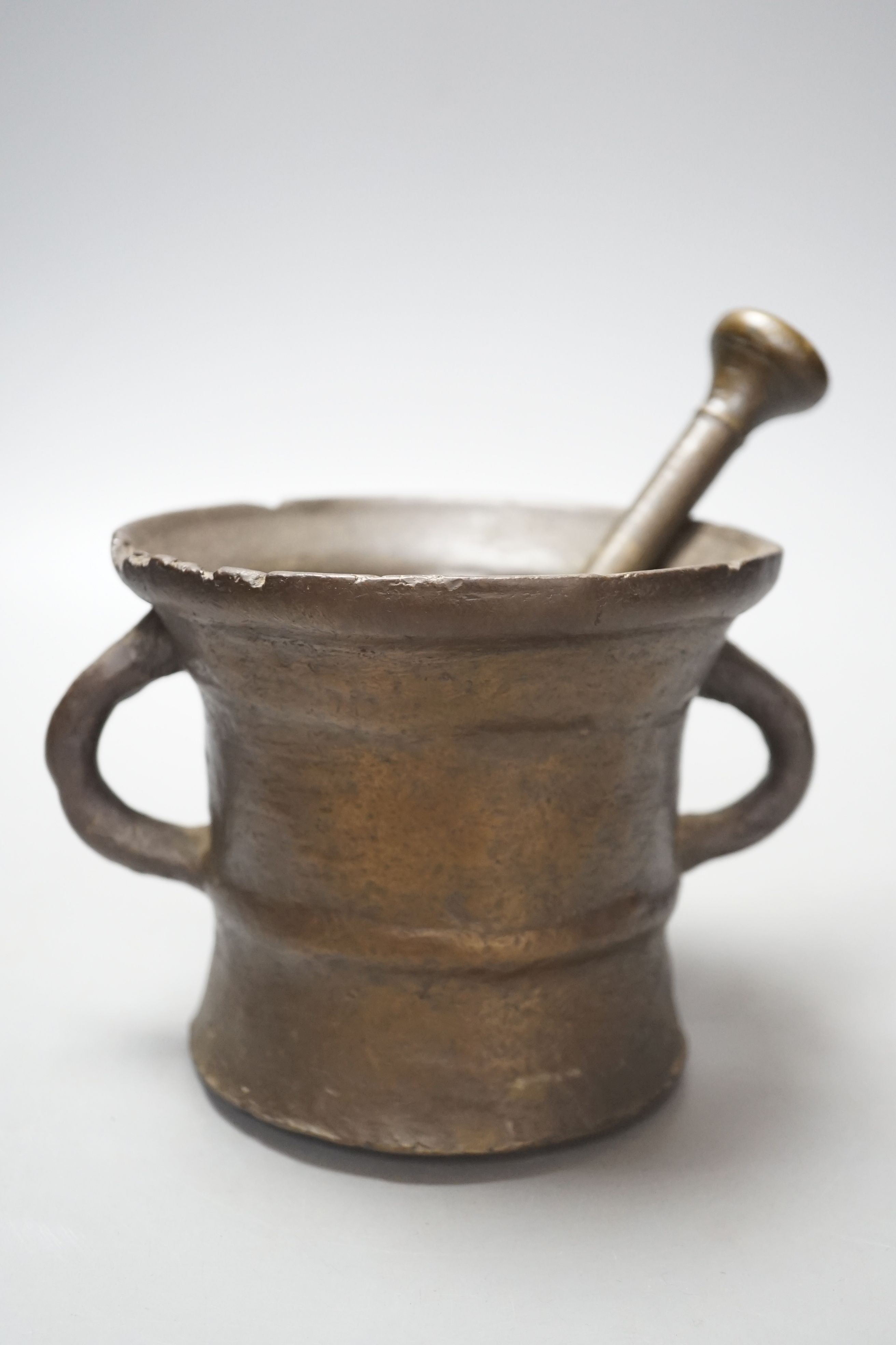 An 18th century bronze pestle and mortar